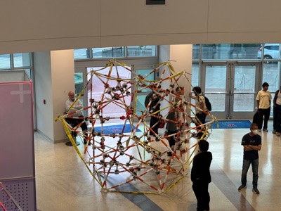 Another view from above of the completed sculpture and visitors examining it